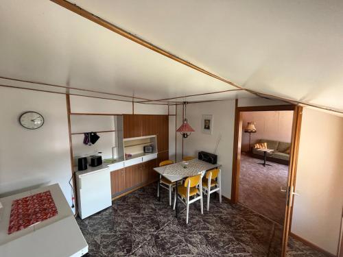 a kitchen and a dining room with a table and chairs at Pure Nostalgie am Scharmützelsee in Wendisch Rietz