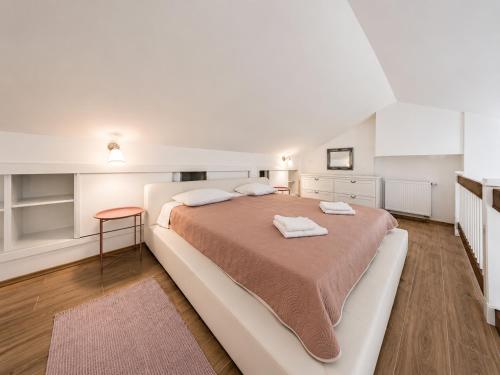a bedroom with a large bed with towels on it at Koko's home in Ston