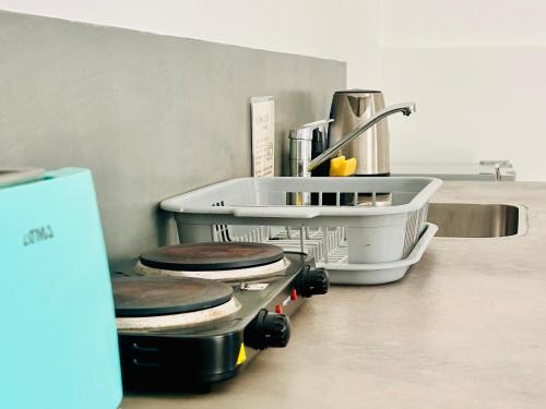 a kitchen with three toilets on a counter at Los Olivos Apart in Cafayate