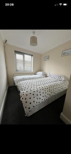 a bedroom with a bed with polka dot sheets at Saddlebrook 156 in Leysdown-on-Sea