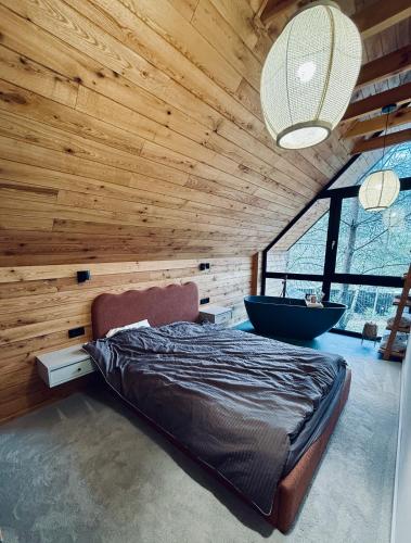 a bedroom with a large bed and a bath tub at Moje sPokoje in Morgowniki