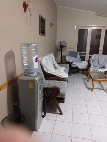 a living room with a room with several beds and a heater at Diamond Beach In Marina, Egyptw in Dawwār Abū Maḩrūs