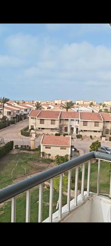 a balcony with a view of a town with houses at Diamond Beach In Marina, Egyptw in Dawwār Abū Maḩrūs