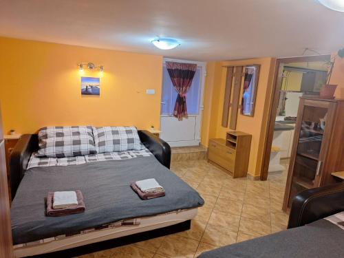 a bedroom with a bed with two towels on it at Szonja Apartman in Egerszalók