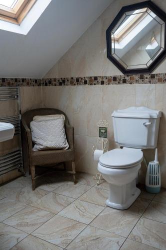 a bathroom with a toilet and a sink and a mirror at Bella Vista in Carlingford