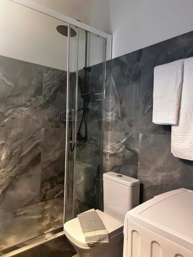 a bathroom with a shower and a toilet at Grand view resort in Argostoli