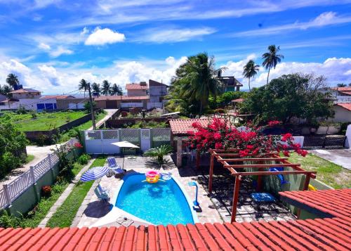 a view of a backyard with a swimming pool at Pitimbu Beach House Rosi in Pitimbu