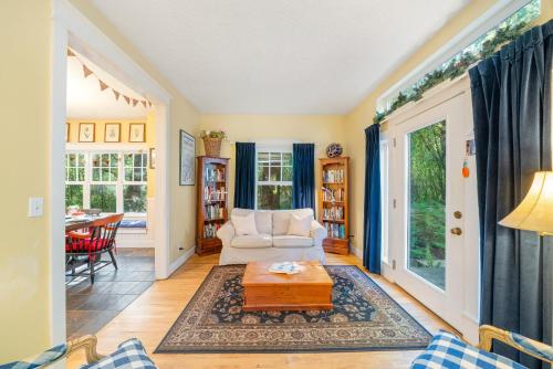 a living room with a couch and a table at Bella Mar in Nehalem