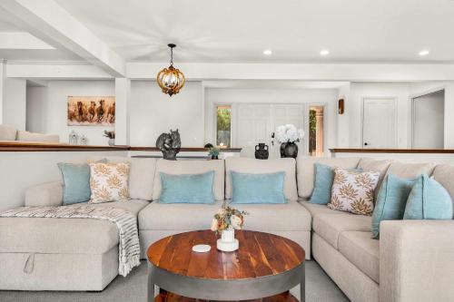 a living room with a couch and a table at Spacious Villa Private Gameroom in Fallbrook