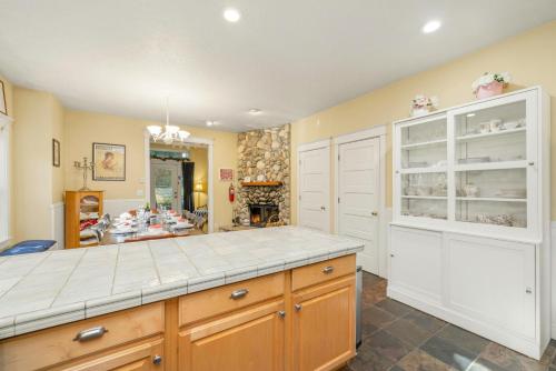 a kitchen with a counter and a fireplace at Bella Mar in Nehalem