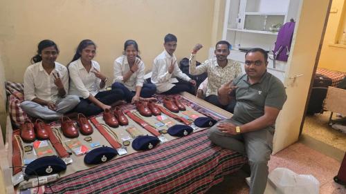a group of people sitting around a table with shoes at Vipul in Kasrāwad