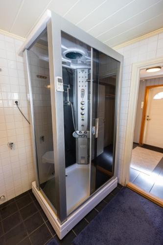 a glass elevator in a bathroom with a shower at Storgata 49 Appartements Svolvær in Svolvær