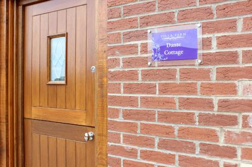 a sign on a brick wall next to a door at Villa Farm York in York