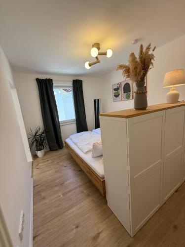 a bedroom with a bed and a desk with a lamp at Ferienwohnung Thomas in Oberau