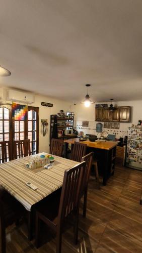 a kitchen with a wooden table and chairs in a room at Hostel y Motoposada Sudaka in Garupá