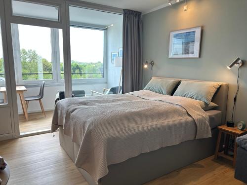 a bedroom with a large bed and a window at Apartment Nordly in Wendtorf