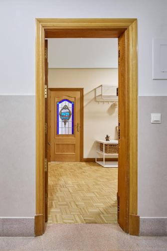 an open door into a room with a stained glass window at Kai in Getaria