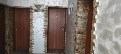 a pair of doors in a brick wall at Вила Никови in Durankulak
