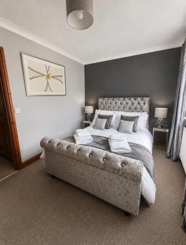 a bedroom with a large bed with a stone frame at 11 Netherby Street in Longtown