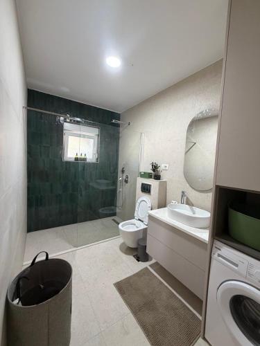 a bathroom with a toilet and a sink and a shower at Casa nel verde in Bar