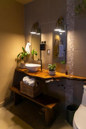 a bathroom with a counter with a sink and a mirror at Habibi Hotel and SPA in San Miguel de Allende