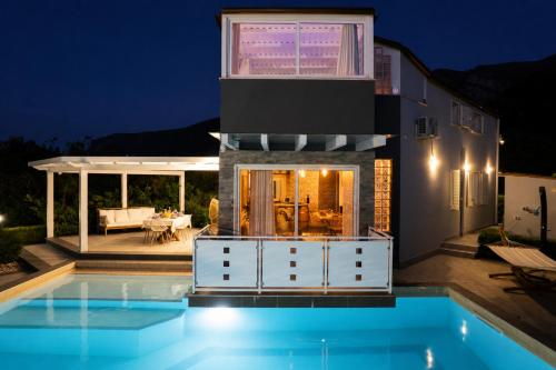 a house with a swimming pool at night at Moresca Luxury Private Villa & Spa in Castellammare del Golfo