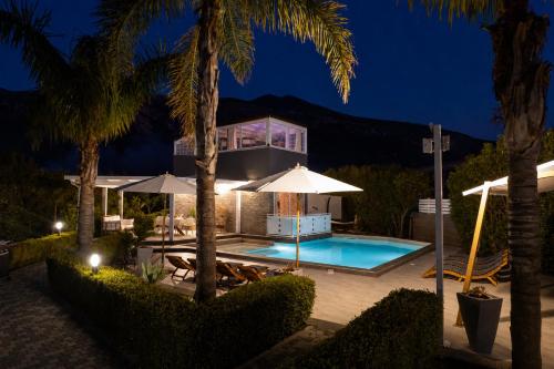 a villa with a swimming pool at night at Moresca Luxury Private Villa & Spa in Castellammare del Golfo