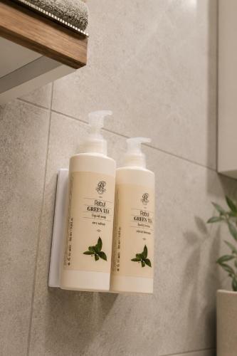 two bottles of lotion sitting on a shelf in a bathroom at Voger Sapanca Lake View in Sapanca