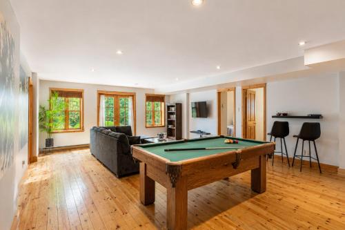 a living room with a pool table in it at Fiddler Lake Resort - Deer 90 in Mille-Isles