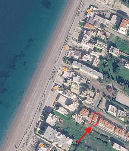 a map of a beach with a red arrow at Two-floor house next to sea in Loutraki