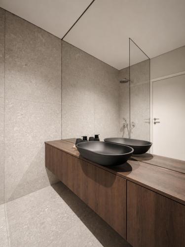 two sinks sitting on a counter in a bathroom at The Loft, An Architects Dream in Târgu-Mureş