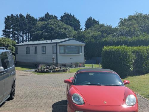 a small red car parked in front of a house at High View in Freystrop