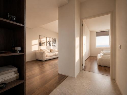 a living room with a bed and a mirror at The Loft, An Architects Dream in Târgu-Mureş