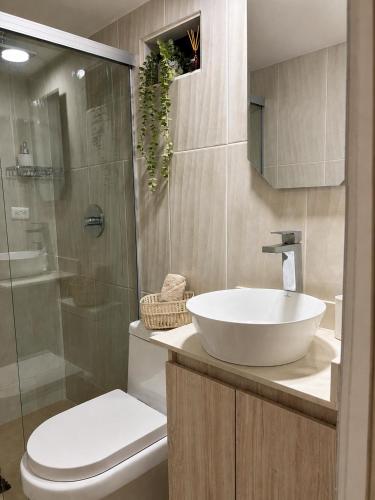 a bathroom with a sink and a toilet and a shower at Loft cerca a Laureles, WIFI, cerca metro, con Balcón, GUARDA MALETAS GRATIS!! in Medellín