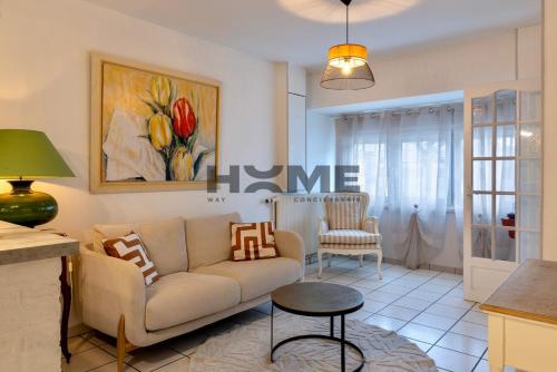 a living room with a couch and a table at Family House in Caudry