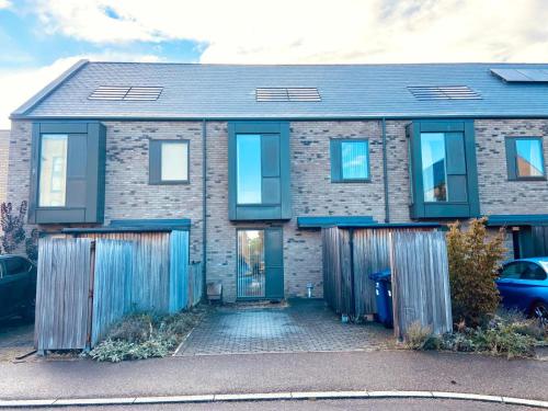 a brick house with a blue door at Superb House Sleeps 7 parking in Cambridge in Trumpington