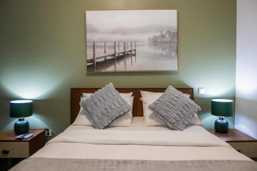 a bedroom with a bed with two lamps and a pier at Aylane Hotel in Nampula