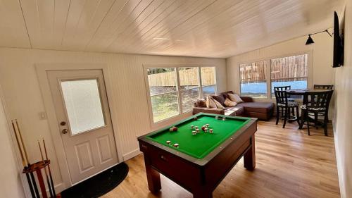 a living room with a pool table in it at Charming Citrus in Inverness