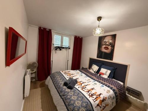 a bedroom with a bed with a picture on the wall at Disney Harmony Flat in Saint-Thibault-des-Vignes