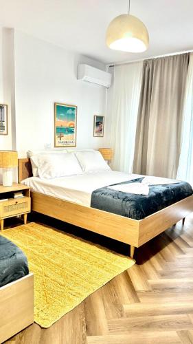 a bedroom with a large bed and a yellow rug at Mar'al Mar Luxury Escape in Himare