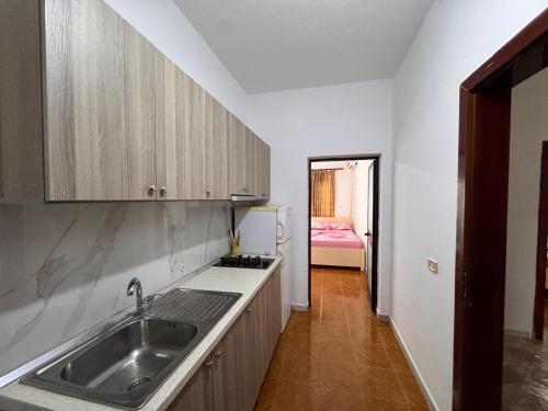 a kitchen with a sink and a counter top at Hotel Gjinaj in Shëngjin