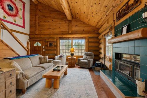 a living room with a couch and a fireplace at Pinedale Cabin in McCall