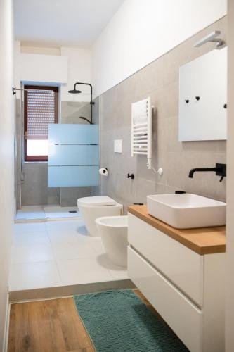a bathroom with two toilets and a sink at Oltremare in Molfetta