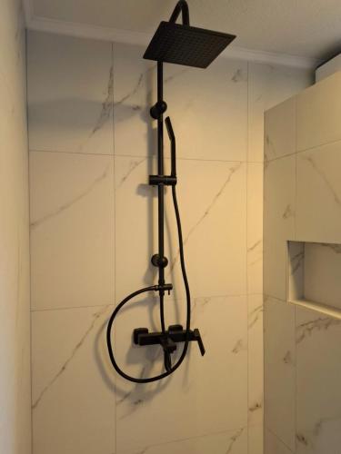 a black lamp hanging on a wall in a bathroom at Drina Escape - Lake View in Višegrad