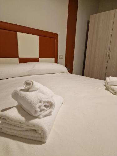 a bedroom with a bed with white towels on it at marte rooms in Centola