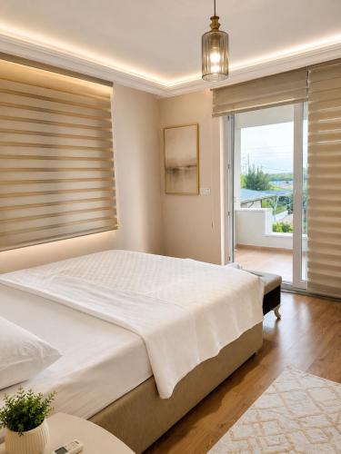a bedroom with a large bed and a large window at Villa Dalaman Müjgan Hanım Konağı in Dalaman