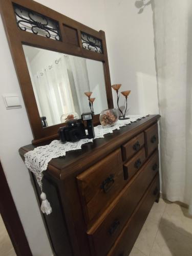 a wooden dresser with a mirror on top of it at Retiro da Charneca in Fazendas de Almeirim