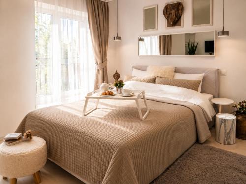 a bedroom with a bed with a table on it at Metropole Apartments Romana Square in Bucharest