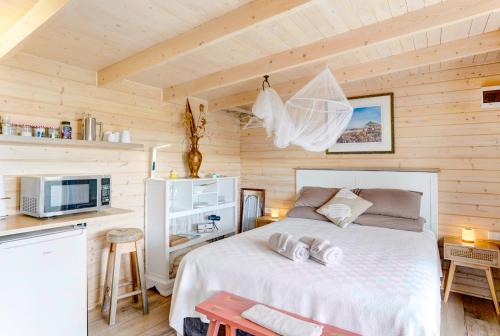 a bedroom with a white bed in a wooden room at The Tawnys Gatehouse in Russell
