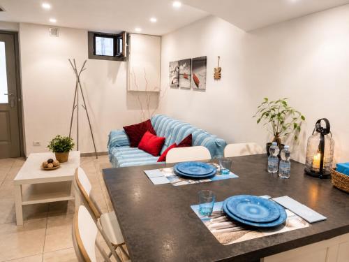 a kitchen and living room with a table and a couch at BASSA MAREA in Gaeta